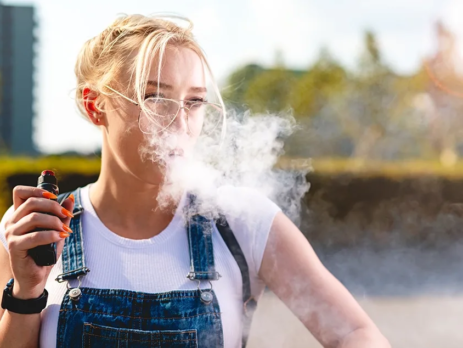 Woman vaping an e-cigarette