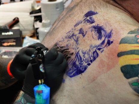 Someone having their back tattooed.