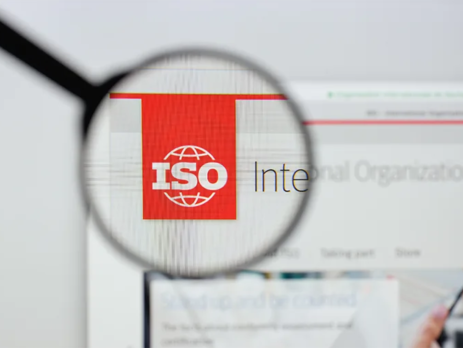 Magnifying glass over the ISO logo