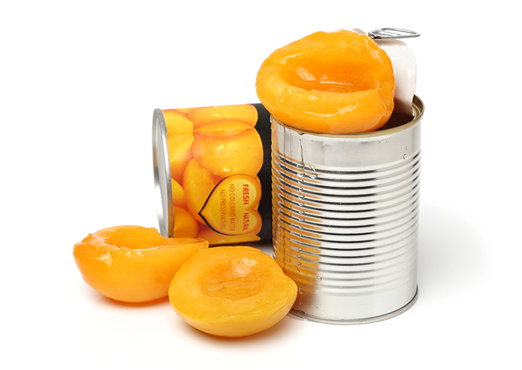 An opened can of peaches with fruit spilling out
