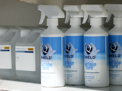 Surface care bottles stacked on a shelf