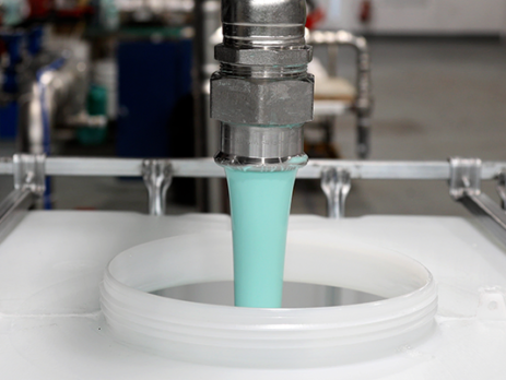 Blue liquid being dispensed into an IBC