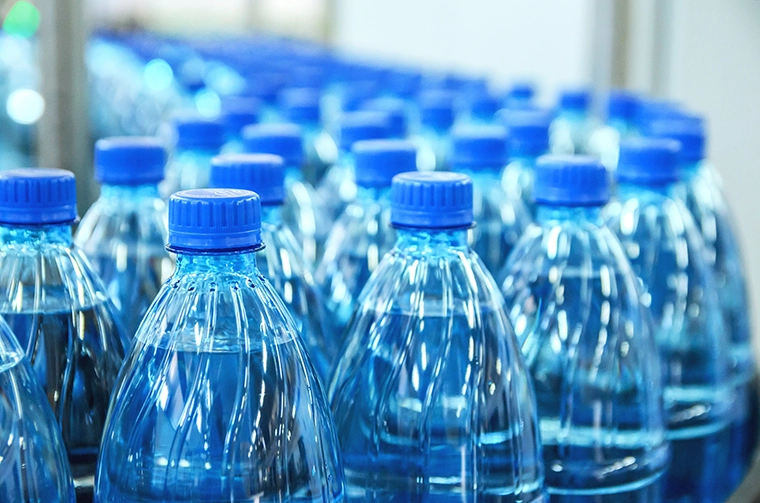 Large bottles of mineral water on a factory production line