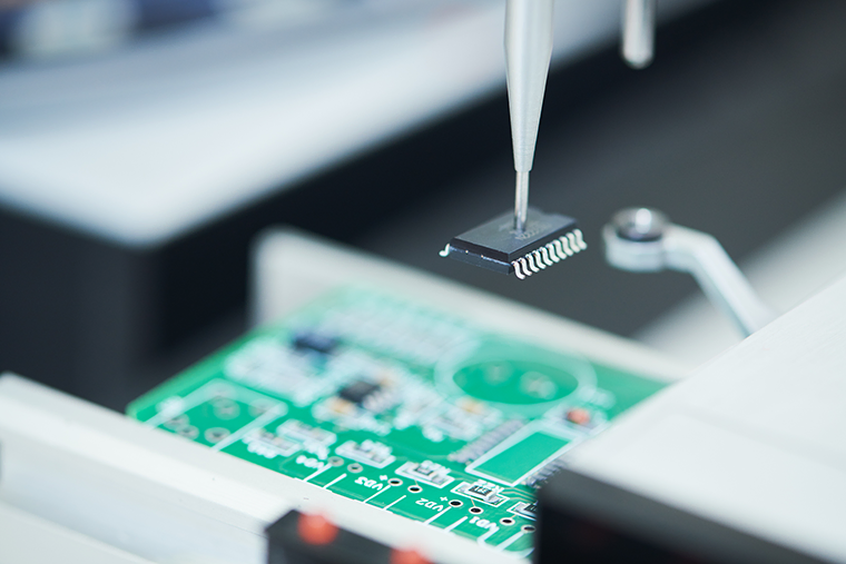 An automated machine robot installing a semiconductor microchip on a board