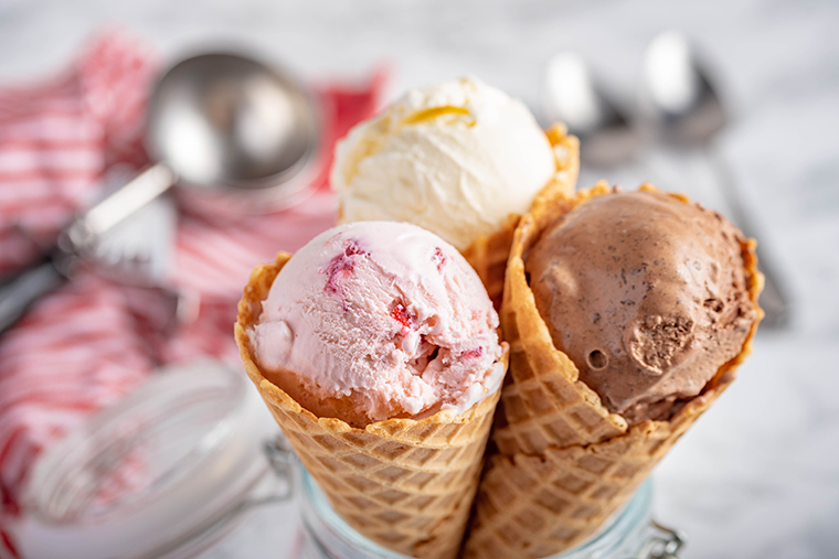 Three cones of vanilla, chocolate, and strawberry ice cream