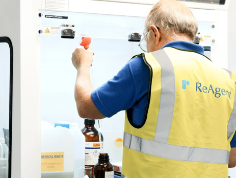 Scientist using a fume hood in a chemistry lab