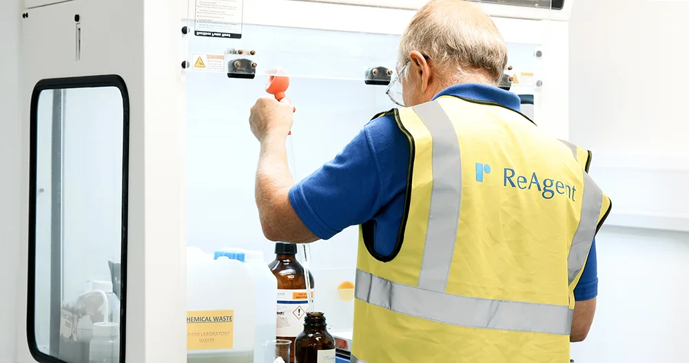 Scientist using a fume hood in a chemistry lab