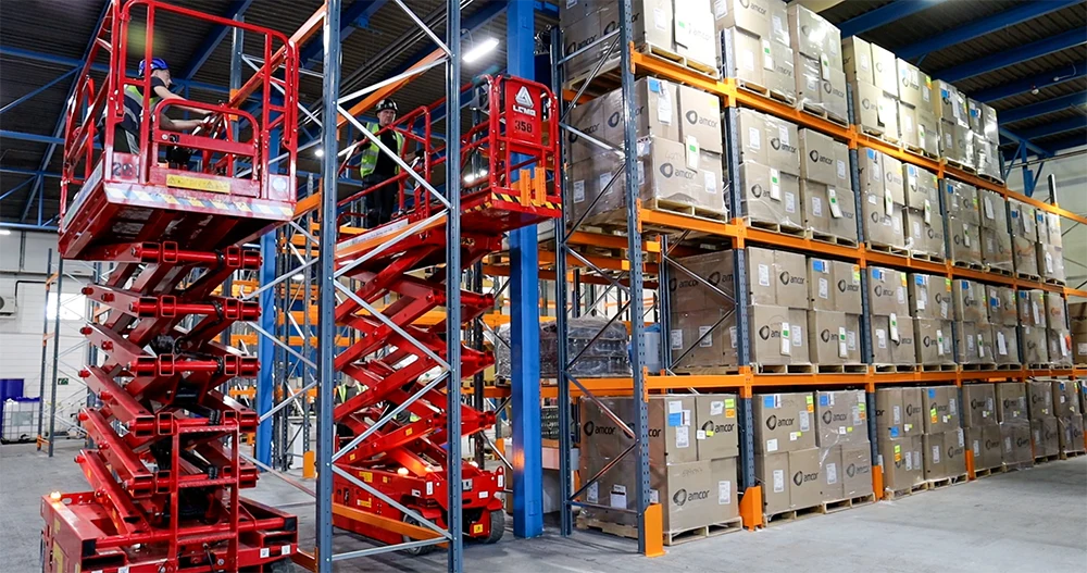 Pallet racking being built and fitted with safety features