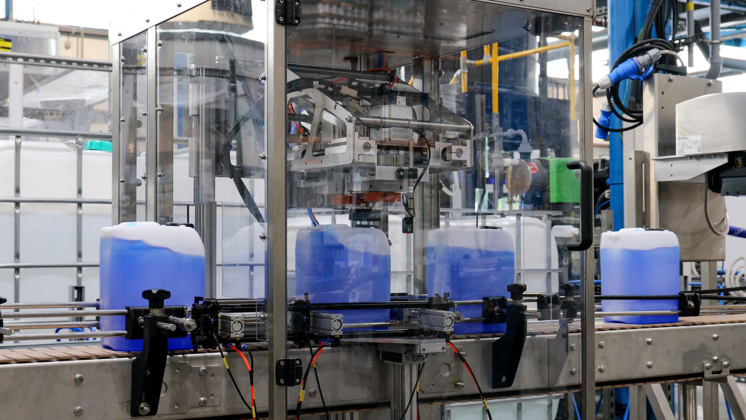 Containers of blue chemicals being filled
