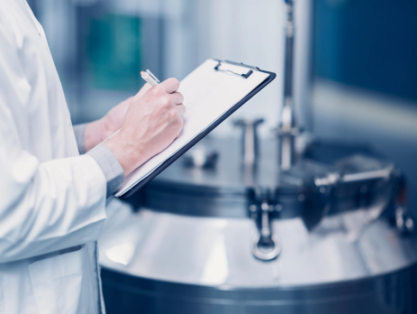 Scientist testing chemcial flow measurement in pharma setting
