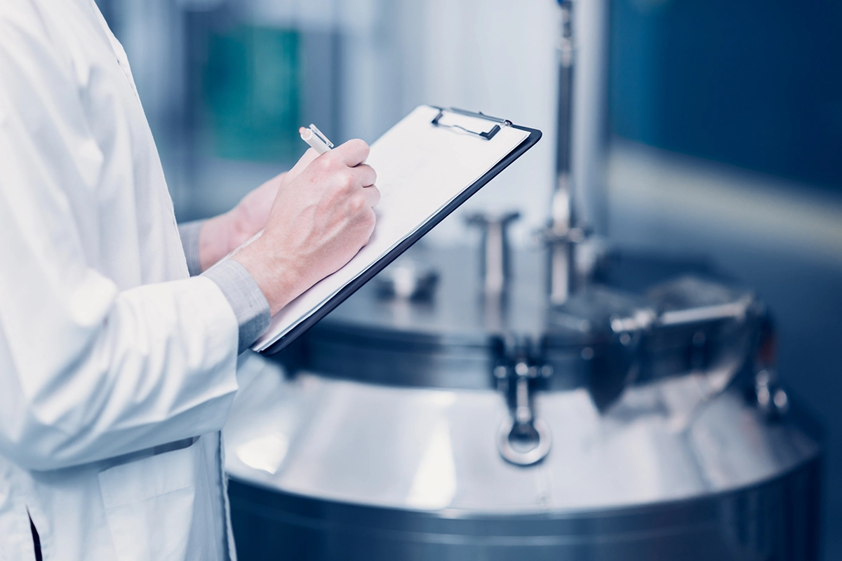 Scientist testing chemcial flow measurement in pharma setting