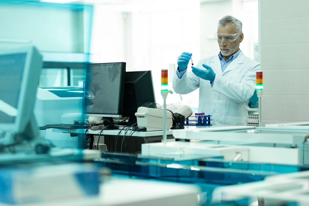 Woker testing chemcial flow measurement in pharma environment