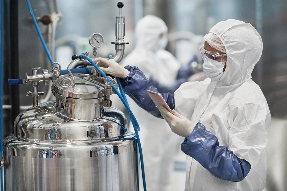 Lab worker inspecting pharamaceutical equipment