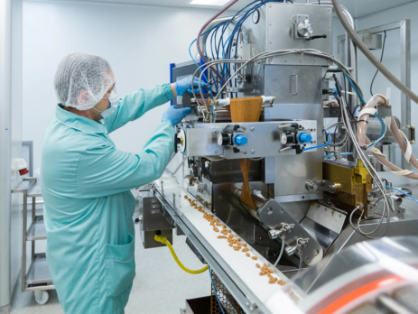 Man examining equipment used in pharmaceutical manufacturing