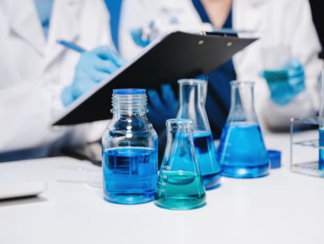 Two chemical lab technicians with a clipboard