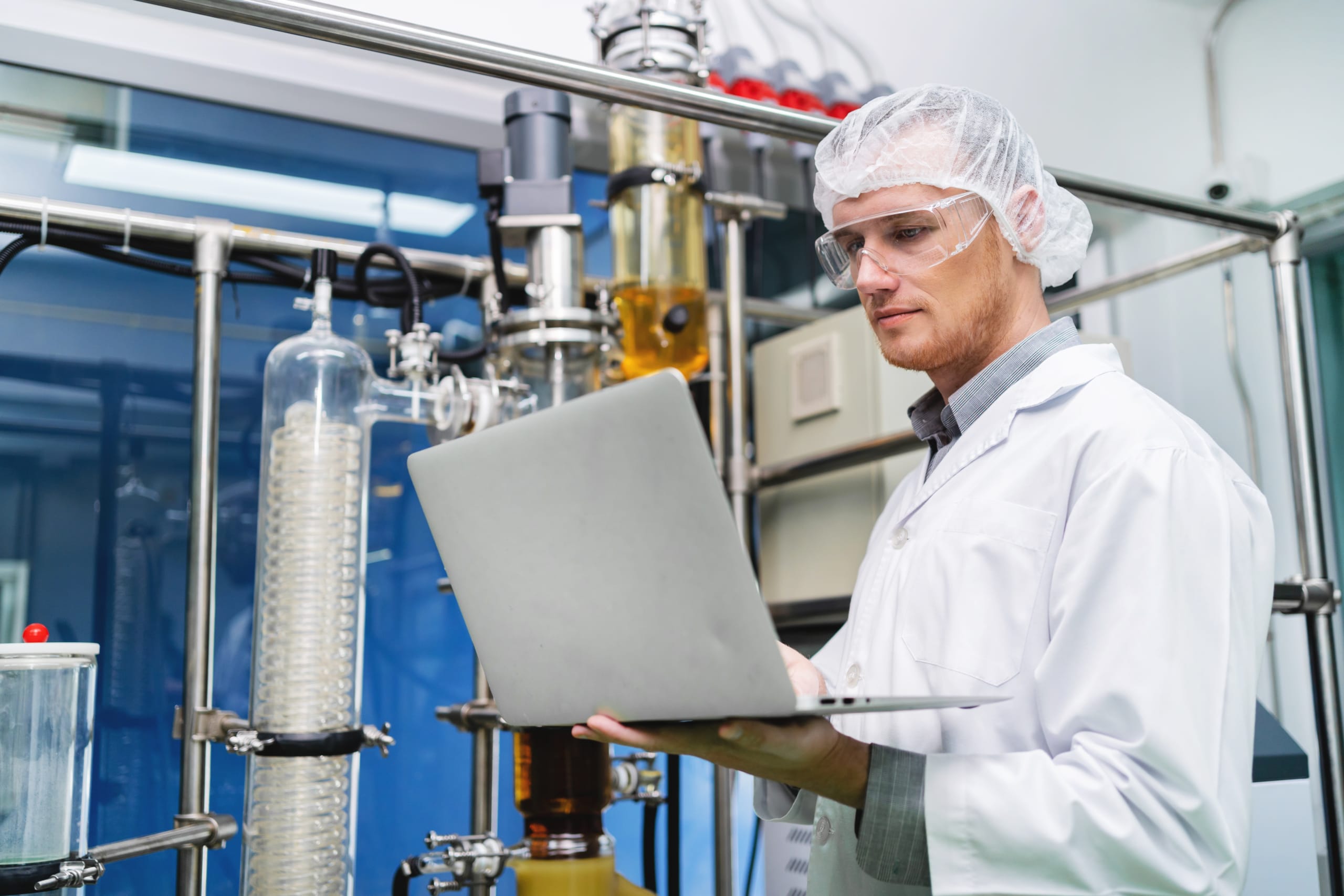 Chemists performing inspection with a laptop