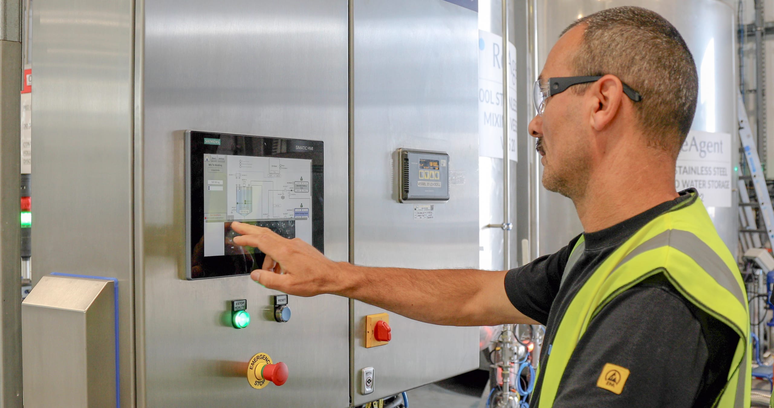 ReAgent team member using a control pad for an ISO tank 