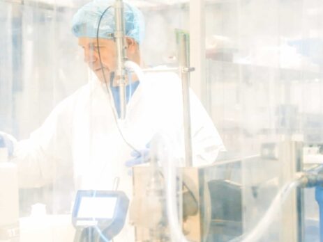 Scientist in a cleanroom wearing full PPE||diameters-of-PM-compared-to-human-hair||cleanroom-classification-table