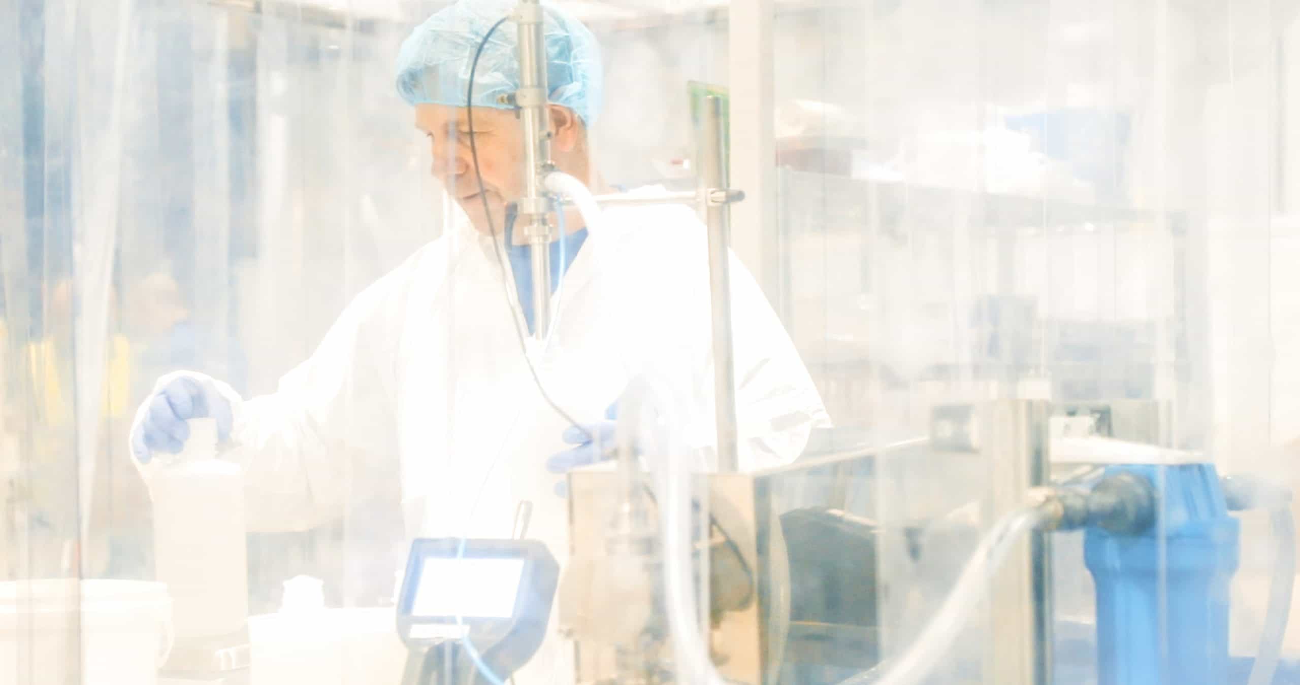 Scientist in a cleanroom wearing full PPE||diameters-of-PM-compared-to-human-hair||cleanroom-classification-table