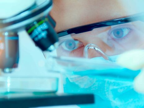 Close up of masked chemical technician analysing microscope||A table showing the quality parameters of water for different ISO grades||Two female scientists or technicians with face protective masks work in laboratory on human blood samples