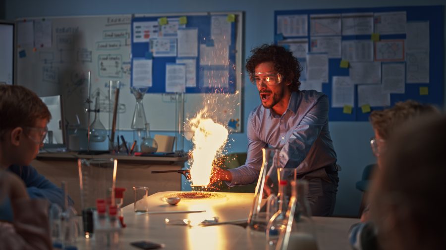 A chemistry teacher conducting an experiment in the classroom
