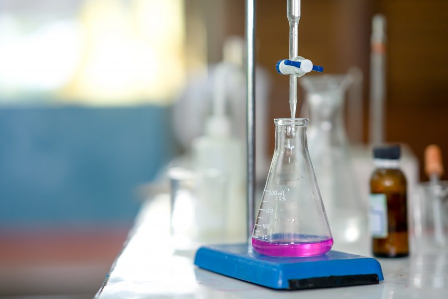 An example of titration in a laboratory setting, with a beaker being used for a neutralisation reaction.