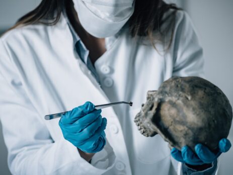 A forensic scientist analysing a skull in a lab||A graphic showing the steps of the scientific method||Forensic scientists examining a burnt out car||A data scientist analysing data on a computer